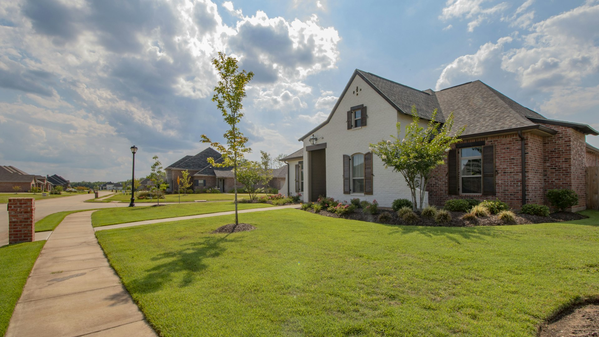 Manicured community landscaping maintained by Beauty Scapes